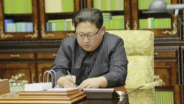 This video grab aired by North Korea’s KRT on November 29, 2017, shows Kim Jong Un signing what is said to be a document on authorizing a missile test November 28, 2017. After two and a half months of relative peace. A Western expert said the missile’s lofted trajectory suggested an actual range of 13,000 kms --enough to hit every major US city. (KRT / AP Video Grab) This video grab aired by North Korea’s KRT on November 29, 2017, shows Kim Jong Un signing what is said to be a document on authorizing a missile test November 28, 2017. After two and a half months of relative peace. A Western expert said the missile’s lofted trajectory suggested an actual range of 13,000 kms --enough to hit every major US city. (KRT / AP Video Grab)
