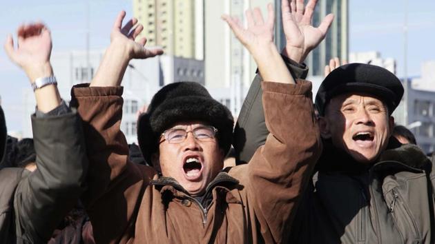 People cheer as they watch a news broadcast at the Pyongyang Train Station announcing North Korean leader Kim Jong Un’s order to test-fire missile Hwasong-15 on Wednesday. Pyongyang said the missile reached an altitude of 4,475 kilometres (2,800 miles) and splashed down 950 kilometres from its launch site. (Jon Chol Jin / AP) People cheer as they watch a news broadcast at the Pyongyang Train Station announcing North Korean leader Kim Jong Un’s order to test-fire missile Hwasong-15 on Wednesday. Pyongyang said the missile reached an altitude of 4,475 kilometres (2,800 miles) and splashed down 950 kilometres from its launch site. (Jon Chol Jin / AP)
