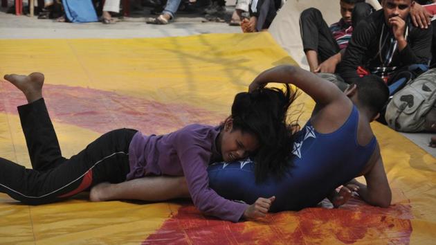 Karan and Khushi Yadav grapple during their match in the competition. From a family of wrestlers, the siblings are trained by their grandfather Kallu Pahalwan. “My father (Vinod Yadav) had participated in national wrestling championships. I want to be an international wrestler. Winning gold for the country in the Olympics is my dream,” Khushi said after besting her brother. (Rajesh Kumar / HT Photo) Karan and Khushi Yadav grapple during their match in the competition. From a family of wrestlers, the siblings are trained by their grandfather Kallu Pahalwan. “My father (Vinod Yadav) had participated in national wrestling championships. I want to be an international wrestler. Winning gold for the country in the Olympics is my dream,” Khushi said after besting her brother. (Rajesh Kumar / HT Photo)
