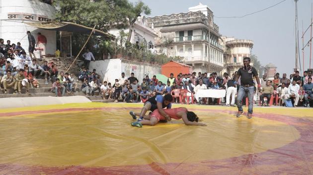 Wrestlers Freedom Yadav (in red) and Bhavana grapple during a bout at Assi Ghat in Varanasi. “Time has changed. Woman wrestlers have won medals and made India proud. We want to encourage women and so we have invited them,” said Vishwambhar Nath Mishra, the shrine’s current head priest. (Rajesh Kumar / HT Photo) Wrestlers Freedom Yadav (in red) and Bhavana grapple during a bout at Assi Ghat in Varanasi. “Time has changed. Woman wrestlers have won medals and made India proud. We want to encourage women and so we have invited them,” said Vishwambhar Nath Mishra, the shrine’s current head priest. (Rajesh Kumar / HT Photo)