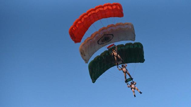 Paratroopers with their Tricolour parachutes during the PT & Equestrian Display of the 133rd NDA course at The National Defence Academy (NDA) in Pune on Wednesday. (Pratham Gokhale/HT Photo) 