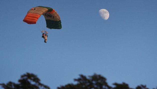 Paratroopers with their Tricolour parachutes during the PT & Equestrian Display of the 133rd NDA course at The National Defence Academy (NDA) in Pune on Wednesday. (Pratham Gokhale/HT Photo) 
