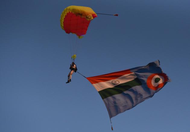 Paratroopers with their Tricolour parachutes during the PT & Equestrian Display of the 133rd NDA course at The National Defence Academy (NDA) in Pune on Wednesday. (Pratham Gokhale/HT Photo) 