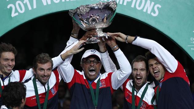 French captain Yannick Noah, center, holds the cup after France won the Davis Cup tennis tournament. (AP) French captain Yannick Noah, center, holds the cup after France won the Davis Cup tennis tournament. (AP)