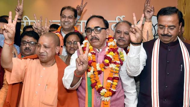 Uttar Pradesh chief minister Yogi Adityanath, deputy CM Keshav Prasad Maurya and BJP state president Mahendra Nath Pandey celebrate the victory of the party in the state civic body elections at the party office in Lucknow on December 1.(PTI Photo)