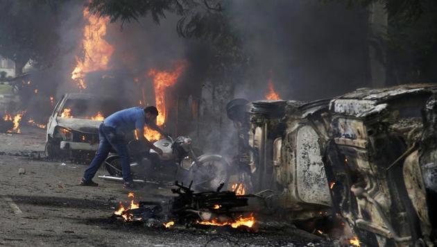 A man lifts a motorbike in a vandalised area by Dera Sacha Sauda sect members in Panchkula, India, Friday, Aug. 25, 2017. Deadly riots broke out after a court convicted Gurmeet Ram Rahim Singh of raping two of his followers. Mobs also attacked journalists and set fire to government buildings and railway stations. (AP File Photo) A man lifts a motorbike in a vandalised area by Dera Sacha Sauda sect members in Panchkula, India, Friday, Aug. 25, 2017. Deadly riots broke out after a court convicted Gurmeet Ram Rahim Singh of raping two of his followers. Mobs also attacked journalists and set fire to government buildings and railway stations. (AP File Photo)
