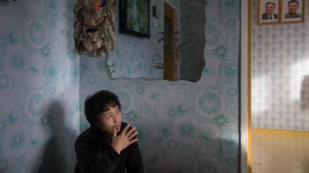 Ra In-Hae, 46, sits in her new home after her old house was damaged by flooding, before the portraits of late North Korean leaders Kim Il-Sung and Kim Jong-Il, near Rason. There used to be more than 5,000 foreign businessmen in Rason, around 80 percent of them Chinese, but officials privately admit some have left. (Ed Jones / AFP) Ra In-Hae, 46, sits in her new home after her old house was damaged by flooding, before the portraits of late North Korean leaders Kim Il-Sung and Kim Jong-Il, near Rason. There used to be more than 5,000 foreign businessmen in Rason, around 80 percent of them Chinese, but officials privately admit some have left. (Ed Jones / AFP)
