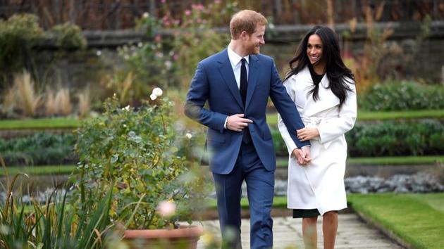 Britain's Prince Harry poses with Meghan Markle in the Sunken Garden of Kensington Palace after a royal announcement of the couple’s engagement on November 27, 2017 in, London, England. (Toby Melville / REUTERS)