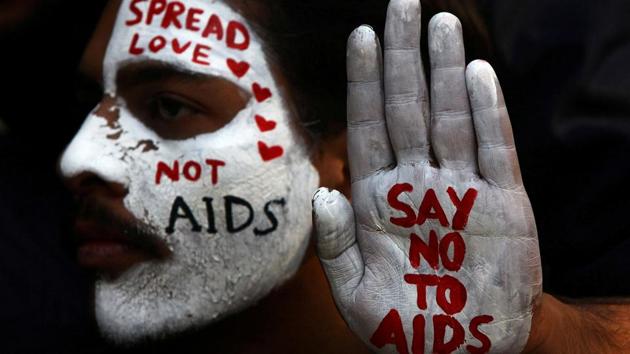 A student displays awareness slogans painted on his hand and face during an HIV/AIDS awareness campaign on World AIDS Day in Chandigarh on December 1, 2017. (Ajay Verma / REUTERS)
