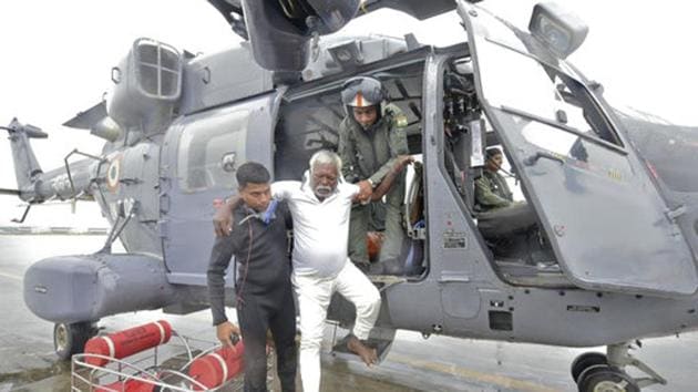 A fisherman who was adrift in the Arabian Sea is escorted down from an Indian Navy helicopter in Thiruvananthapuram after being rescued. (AP) A fisherman who was adrift in the Arabian Sea is escorted down from an Indian Navy helicopter in Thiruvananthapuram after being rescued. (AP)