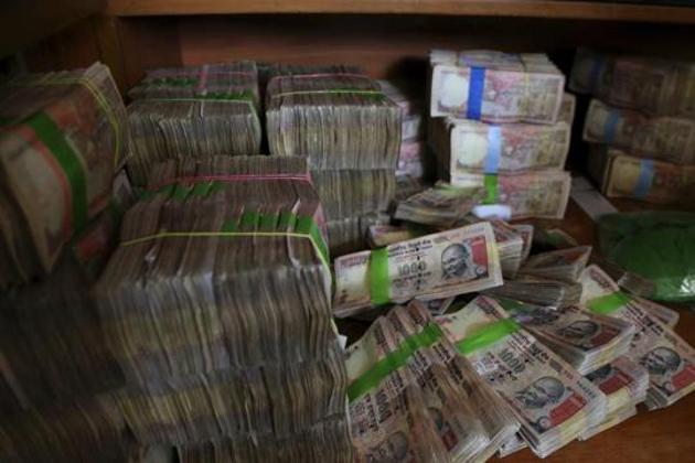 Discontinued currency notes of 1,000 denomination are seen after they were deposited by people at a bank in Bangalore in November 2016.(AP File Photo)