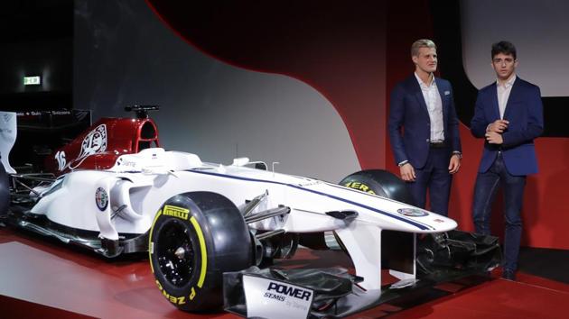 Drivers Marcus Ericsson of Sweden (left) and Charles Leclerc of Monaco unveil the Alfa Romeo Sauber F1 team car on the occasion of its official presentation in Arese, Italy, on Saturday. The Alfa Romeo Sauber F1 Team will compete in the 2018 Formula One World Championship.(AP)