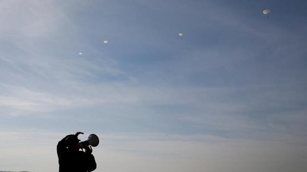 An instructor guides students from the General Yermolov Cadet School during a parachuting exercise from an airplane at an airdrome in the village of Novomaryevskaya. (Eduard Korniyenko / REUTERS) An instructor guides students from the General Yermolov Cadet School during a parachuting exercise from an airplane at an airdrome in the village of Novomaryevskaya. (Eduard Korniyenko / REUTERS)
