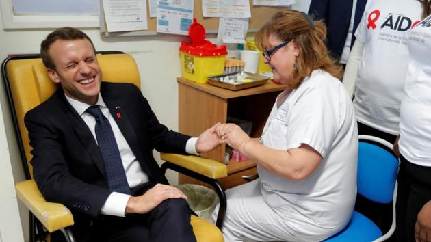 A nurse takes blood for a HIV test for French President Emmanuel Macron as he visits the Delafontaine Hospital as part of the World AIDS Day on December 1, 2017 in Saint-Denis, France. (Charles Platiau / REUTERS)