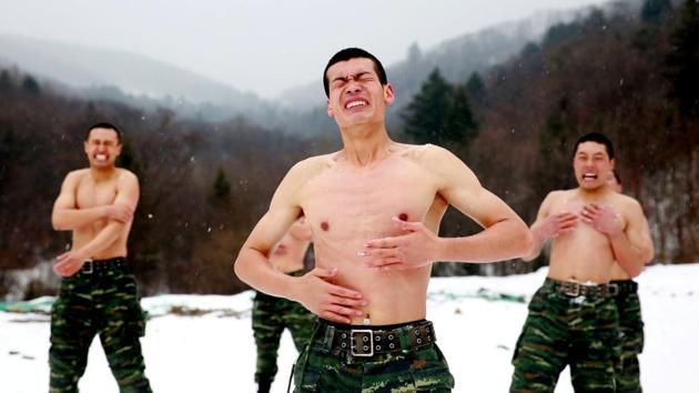 Paramilitary soldiers rub snow onto their bodies in a temperature around negative 25 degrees Celsius (minus 13 degrees Fahrenheit) during a winter training session at a snowfield on November 28, 2017 in Changchun, Jilin province, China. (REUTERS)