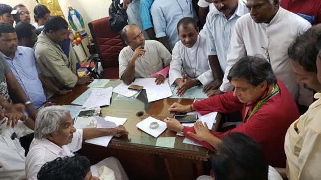 Former Kerala CM Oommen Chandy (front, L) and Shashi Tharoor (R) meet affected families in Thiruvananthapuram. A red alert has been issued to Lakshadweep as the cyclone continues to move towards the archipelago and is expected to make landfall on the island on Saturday. (HT Photo) 