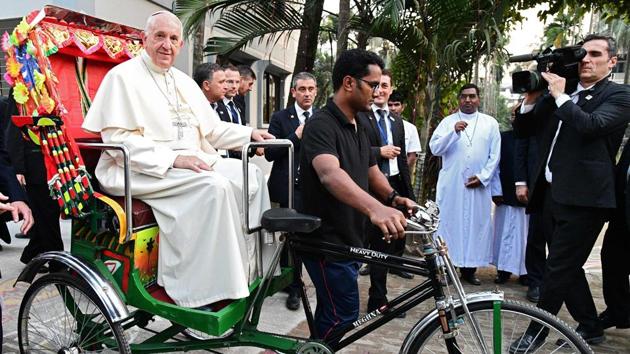 Pope Francis rides in a cycle rickshaw during the second day of his visit to Bangladesh on December 1, 2017 in Dhaka, Bangladesh. Pope Francis arrived in Bangladesh from Myanmar on November 30 for the second stage of a visit that has been overshadowed by the plight of hundreds of thousands of Rohingya refugees. (Vincenzo Pinto / AFP)