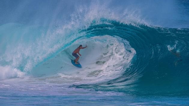 Hawaiian surfer Tamayo Perry goes into the tube at "Insanities" in Haleiwa on the North shore of Oahu as the first "big day" of Winter delivered the first big waves of the season on November 29, 2017 in Hawaii . (Brian Bielmann / AFP)