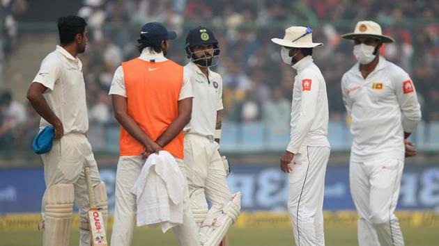 Sri Lanka captain Dinesh Chandimal (2R) wears a face mask as he speaks with Indian cricket team captain Virat Kohli (3L). (AFP) Sri Lanka captain Dinesh Chandimal (2R) wears a face mask as he speaks with Indian cricket team captain Virat Kohli (3L). (AFP)