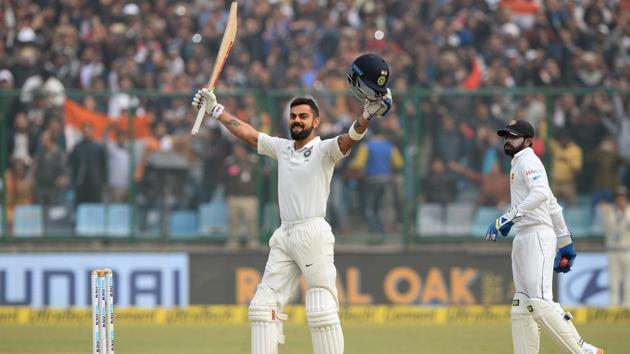 Virat Kohli raises his bat after completing his double century during the second day of the third Test match between India and Sri Lanka at the Feroz Shah Kotla Cricket Stadium in New Delhi on Sunday.(AFP)