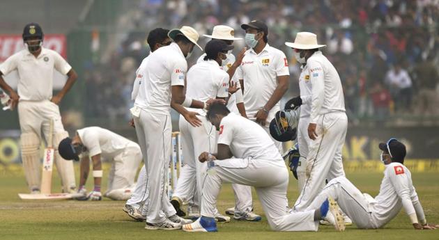 Sri Lanka cricket team players wear anti-pollution masks on the field as the air quality deteriorated during the second day of their third Test against Indian cricket team at Frerozeshah Kotla stadium in New Delhi on Sunday.(PTI)