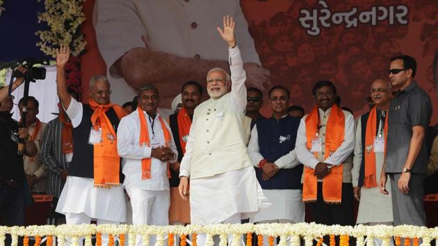 Prime Minister Narendra Modi waves on his arrival to address a rally at Surendranagar, some 130 kms from Ahmedabad on December 3. (AFP Photo) Prime Minister Narendra Modi waves on his arrival to address a rally at Surendranagar, some 130 kms from Ahmedabad on December 3. (AFP Photo)