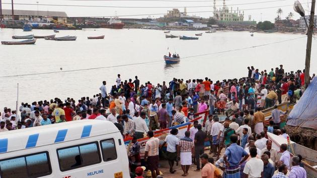 Huge crowd of fishermen families wait for those who yet to return home at Vizhinjam harbour in Thiruvananthapuram on Saturday.(PTI)