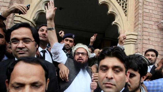 Hafiz Saeed reacts to supporters as he walks out of a court after it ordered his release from house arrest in Lahore.(Reuters) Hafiz Saeed reacts to supporters as he walks out of a court after it ordered his release from house arrest in Lahore.(Reuters)