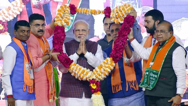 Prime Minister Narendra Modi being felicitated during an election campaign rally for the state assembly election in Rajkot on Sunday.(PTI)