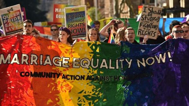 Supporters of same sex marriage carry banners and shout slogans as they march in Sydney on August 6, 2017. (AFP) Supporters of same sex marriage carry banners and shout slogans as they march in Sydney on August 6, 2017. (AFP)