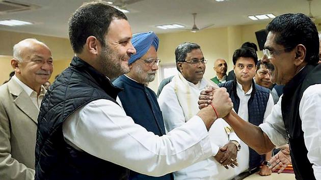 Congress vice president Rahul Gandhi is greeted by a party colleague after filing his nomination for the party president’s post on New Delhi on Monday. Also, seen are former prime minister Manmohan Singh, Congress MP Jyotiraditya Scindia and Karnataka chief minister Siddaramaiah. (PTI) Congress vice president Rahul Gandhi is greeted by a party colleague after filing his nomination for the party president’s post on New Delhi on Monday. Also, seen are former prime minister Manmohan Singh, Congress MP Jyotiraditya Scindia and Karnataka chief minister Siddaramaiah. (PTI)