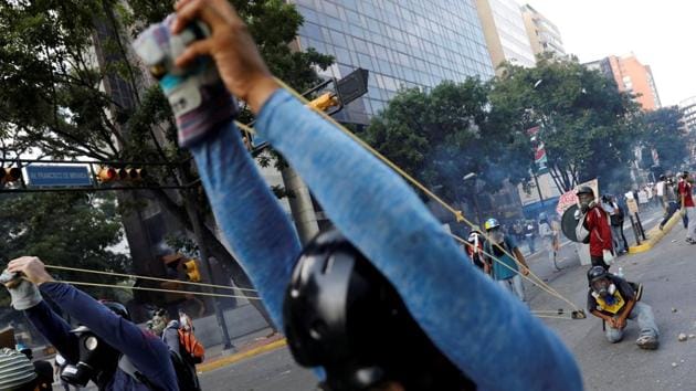 Demonstrators use a giant slingshot against security forces during a rally in Caracas, Venezuela on May 20, 2017. The tipping point came in March when the pro-Maduro Supreme Court essentially took over functions of the opposition-led National Assembly. Though the ruling was later modified, it triggered hundreds of thousands on to the streets, decrying economic hardship, demanding a presidential election, urging foreign humanitarian aid, and seeking freedom for jailed activists. (Carlos Garcia Rawlins / REUTERS) Demonstrators use a giant slingshot against security forces during a rally in Caracas, Venezuela on May 20, 2017. The tipping point came in March when the pro-Maduro Supreme Court essentially took over functions of the opposition-led National Assembly. Though the ruling was later modified, it triggered hundreds of thousands on to the streets, decrying economic hardship, demanding a presidential election, urging foreign humanitarian aid, and seeking freedom for jailed activists. (Carlos Garcia Rawlins / REUTERS)
