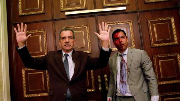 Opposition lawmaker Luis Stefanelli (L) gestures next to fellow opposition lawmaker Leonardo Regnault after a group of Maduro supporters burst into the National Assembly, in Caracas on July 05, 2017. While global opinion hardened against Maduro, gangs burst into the National Assembly and beat up opposition lawmakers. In a matter of days, the nation’s best-known jailed opposition leader, Leopoldo Lopez, was released from prison, placed on home arrest, taken back to jail, allowed home again. (Carlos Garcia Rawlins / REUTERS) Opposition lawmaker Luis Stefanelli (L) gestures next to fellow opposition lawmaker Leonardo Regnault after a group of Maduro supporters burst into the National Assembly, in Caracas on July 05, 2017. While global opinion hardened against Maduro, gangs burst into the National Assembly and beat up opposition lawmakers. In a matter of days, the nation’s best-known jailed opposition leader, Leopoldo Lopez, was released from prison, placed on home arrest, taken back to jail, allowed home again. (Carlos Garcia Rawlins / REUTERS)