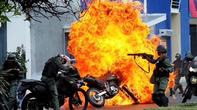 Riot security forces clash with demonstrators as a motorcycle is set on fire during a protest against President Maduro's government in San Cristobal, Venezuela on May 29, 2017. The deaths, injuries and arrests mounted. Over the chaotic months, at least 125 people died, thousands were injured and thousands were jailed. (Carlos Eduardo Ramirez / REUTERS) Riot security forces clash with demonstrators as a motorcycle is set on fire during a protest against President Maduro's government in San Cristobal, Venezuela on May 29, 2017. The deaths, injuries and arrests mounted. Over the chaotic months, at least 125 people died, thousands were injured and thousands were jailed. (Carlos Eduardo Ramirez / REUTERS)