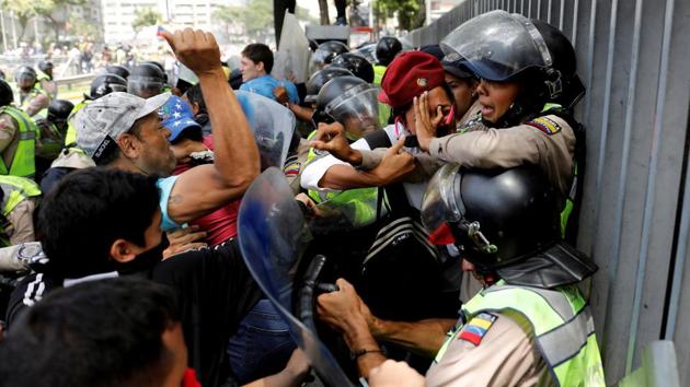 Demonstrators scuffle with security forces during an opposition rally in Caracas. Most recently, in November, Venezuela said it planned to renegotiate its entire foreign debt, adding another dimension to the deepening national crisis. (Carlos Garcia Rawlins / REUTERS) Demonstrators scuffle with security forces during an opposition rally in Caracas. Most recently, in November, Venezuela said it planned to renegotiate its entire foreign debt, adding another dimension to the deepening national crisis. (Carlos Garcia Rawlins / REUTERS)