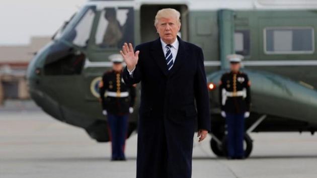 US President Donald Trump waves as he boards Air Force One at John F. Kennedy International Airport in New York, before his departure back to Washington, US, December 2, 2017. (REUTERS)