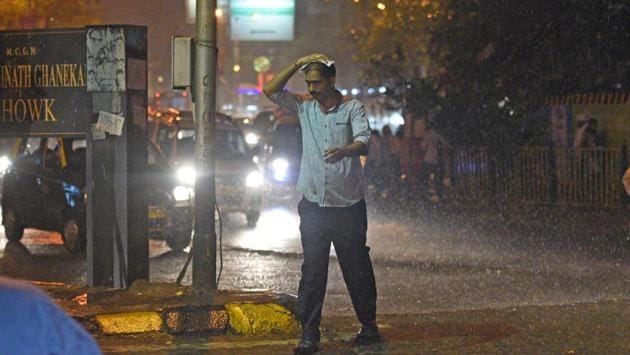 A man crosses a road during rainfall at Dadar in Mumbai on Monday night. Maharashtra closed down schools and colleges, including those in Mumbai and adjoining areas in the wake of forecasted rain triggered by Ockhi on Tuesday. (Satyabrata Tripathy / HT Photo) A man crosses a road during rainfall at Dadar in Mumbai on Monday night. Maharashtra closed down schools and colleges, including those in Mumbai and adjoining areas in the wake of forecasted rain triggered by Ockhi on Tuesday. (Satyabrata Tripathy / HT Photo)