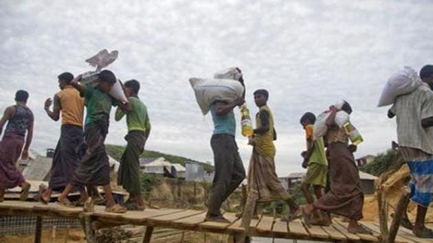 Rohingya Muslims, who crossed over from Myanmar into Bangladesh, walk on a bridge at Kutupalong refugee camp in Ukhiya, Bangladesh, Wednesday, November 15, 2017. (AP Photo) Rohingya Muslims, who crossed over from Myanmar into Bangladesh, walk on a bridge at Kutupalong refugee camp in Ukhiya, Bangladesh, Wednesday, November 15, 2017. (AP Photo)