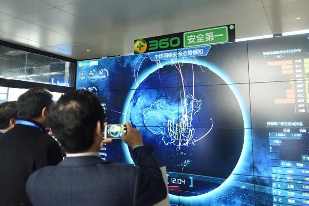 This photo taken on December 4, 2017 shows a man taking pictures of internet security data displayed on a screen at the Qihoo booth during the 4th World Internet Conference in Wuzhen in China's eastern Zhejiang province. (AFP) This photo taken on December 4, 2017 shows a man taking pictures of internet security data displayed on a screen at the Qihoo booth during the 4th World Internet Conference in Wuzhen in China's eastern Zhejiang province. (AFP)