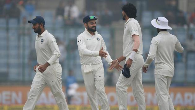 India captain Virat Kohli (2 L) celebrates with Ishant Sharma the dismissal of Sri Lanka captain Dinesh Chandimal during the fourth day of third Test . (AFP) India captain Virat Kohli (2 L) celebrates with Ishant Sharma the dismissal of Sri Lanka captain Dinesh Chandimal during the fourth day of third Test . (AFP)