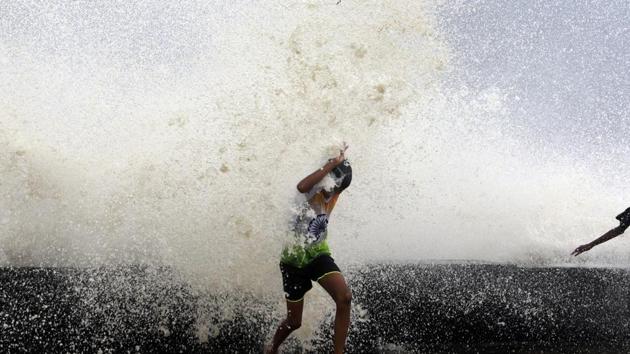 A boy gets drenched in waves during high tide in the Arabian Sea in Mumbai on Tuesday. (AP Photo) A boy gets drenched in waves during high tide in the Arabian Sea in Mumbai on Tuesday. (AP Photo)