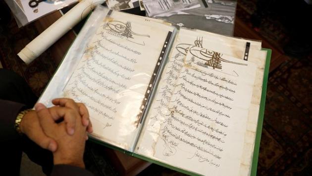Adeeb Joudeh, shows royal decrees called "Fermans", by rulers of the Ottoman empire, bestowing the key custodianship of the Church upon his family. Historians differ on the roots of the arrangement. Some researchers say Saladin most likely bestowed the guardianship upon two families in order to assert Muslim dominance over Christianity. Documentation, however, only goes back to the 16th century, Joudeh said. (Ronen Zvulun / REUTERS) Adeeb Joudeh, shows royal decrees called "Fermans", by rulers of the Ottoman empire, bestowing the key custodianship of the Church upon his family. Historians differ on the roots of the arrangement. Some researchers say Saladin most likely bestowed the guardianship upon two families in order to assert Muslim dominance over Christianity. Documentation, however, only goes back to the 16th century, Joudeh said. (Ronen Zvulun / REUTERS)