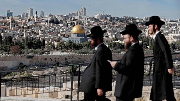 Ultra Orthodox Jews are seen walking in the city of Jerusalem in the Mount of Olives with the Dome of the Rock mosque in the background (AFP) Ultra Orthodox Jews are seen walking in the city of Jerusalem in the Mount of Olives with the Dome of the Rock mosque in the background (AFP)