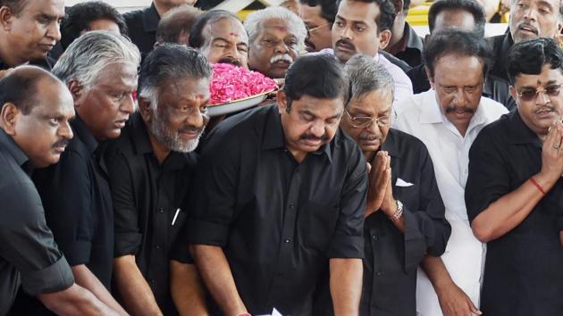 Chief minister K Palaniswami, deputy chief minister O Panneerselvam and senior government officials clad in black dresses paying their respects to the late AIADMK supremo and former chief minister J Jayalalithaa on her first death anniversary at her memorial near shores of Marina in Chennai on Tuesday. (PTI Photo) Chief minister K Palaniswami, deputy chief minister O Panneerselvam and senior government officials clad in black dresses paying their respects to the late AIADMK supremo and former chief minister J Jayalalithaa on her first death anniversary at her memorial near shores of Marina in Chennai on Tuesday. (PTI Photo)