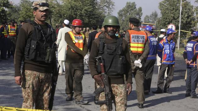 Pakistani army personnel cordon off the area of suicide attack in Peshawar, Pakistan, Friday, Nov. 24, 2017. A suicide bomber struck a vehicle carrying the deputy provincial police chief, killing him and his guard and wounding numerous others, police said. (AP Photo/Muhammad Sajjad) (AP) Pakistani army personnel cordon off the area of suicide attack in Peshawar, Pakistan, Friday, Nov. 24, 2017. A suicide bomber struck a vehicle carrying the deputy provincial police chief, killing him and his guard and wounding numerous others, police said. (AP Photo/Muhammad Sajjad) (AP)