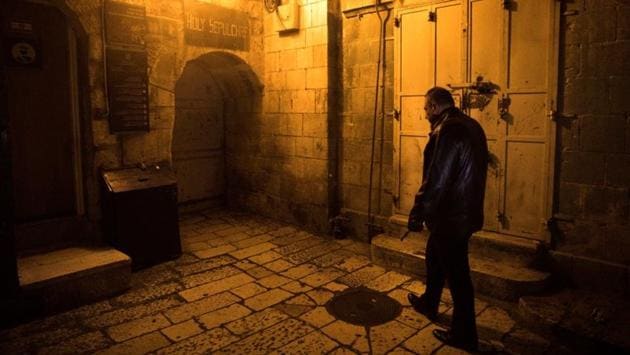 Adeeb Joudeh, the custodian of the ancient key to the Church of the Holy Sepulchre, walks as he holds the church key in Jerusalem's Old City. Centuries ago, the imposing iron key was entrusted to his family, one of Jerusalem’s most prominent clans, says Joudeh. (Ronen Zvulun / REUTERS) Adeeb Joudeh, the custodian of the ancient key to the Church of the Holy Sepulchre, walks as he holds the church key in Jerusalem's Old City. Centuries ago, the imposing iron key was entrusted to his family, one of Jerusalem’s most prominent clans, says Joudeh. (Ronen Zvulun / REUTERS)
