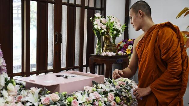 A Buddhist monk blesses the body of Dollar, a six-year-old Shitzu dog, during her funeral at Wat Krathum Suea Pla Buddhist temple in Bangkok. Pet cremations, complete with Buddhist rituals, are popping up across Bangkok for dogs, cats and even monkeys. In the devout Buddhist kingdom some pet owners believe the monk-led send off will boost their pets’ chances of being reincarnated as a higher being. (Lillian Suwanrumpha / AFP)