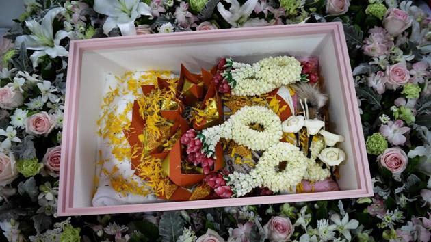 Dollar, inside a coffin with flower garlands and gold joss paper during her funeral. “In this life, she (Dollar) couldn’t go to the temples to make merit for herself. This is the only thing we can do for her,” Pimrachaya, who is a banker, said. (Lillian Suwanrumpha / AFP)