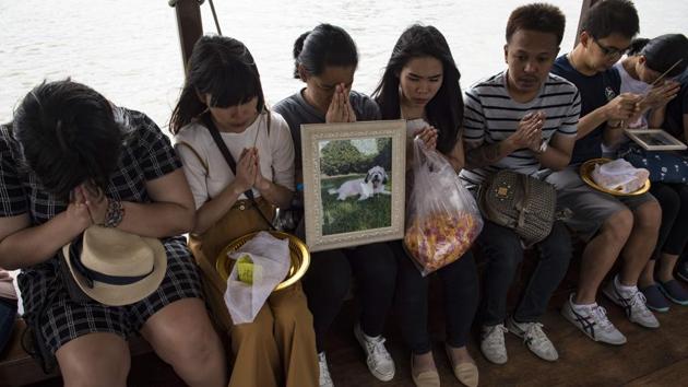 Mourners pray for their pets before releasing their bones and ashes in the Chaopraya river during funeral rites in Bangkok. The trend while particularly popular in Japan is catching on fast as Thais increasingly see pets as family members. At least three temples offer daily services of a symbolic ritual returning earthly remains to nature. (Lillian Suwanrumpha / AFP)