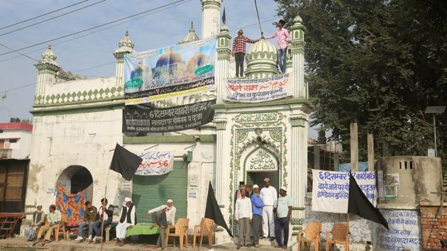 Muslims hoist black flags on a mosque on the 25th anniversary of the Babri Masjid demolition in Ayodhya on Wednesday.(PTI Photo)